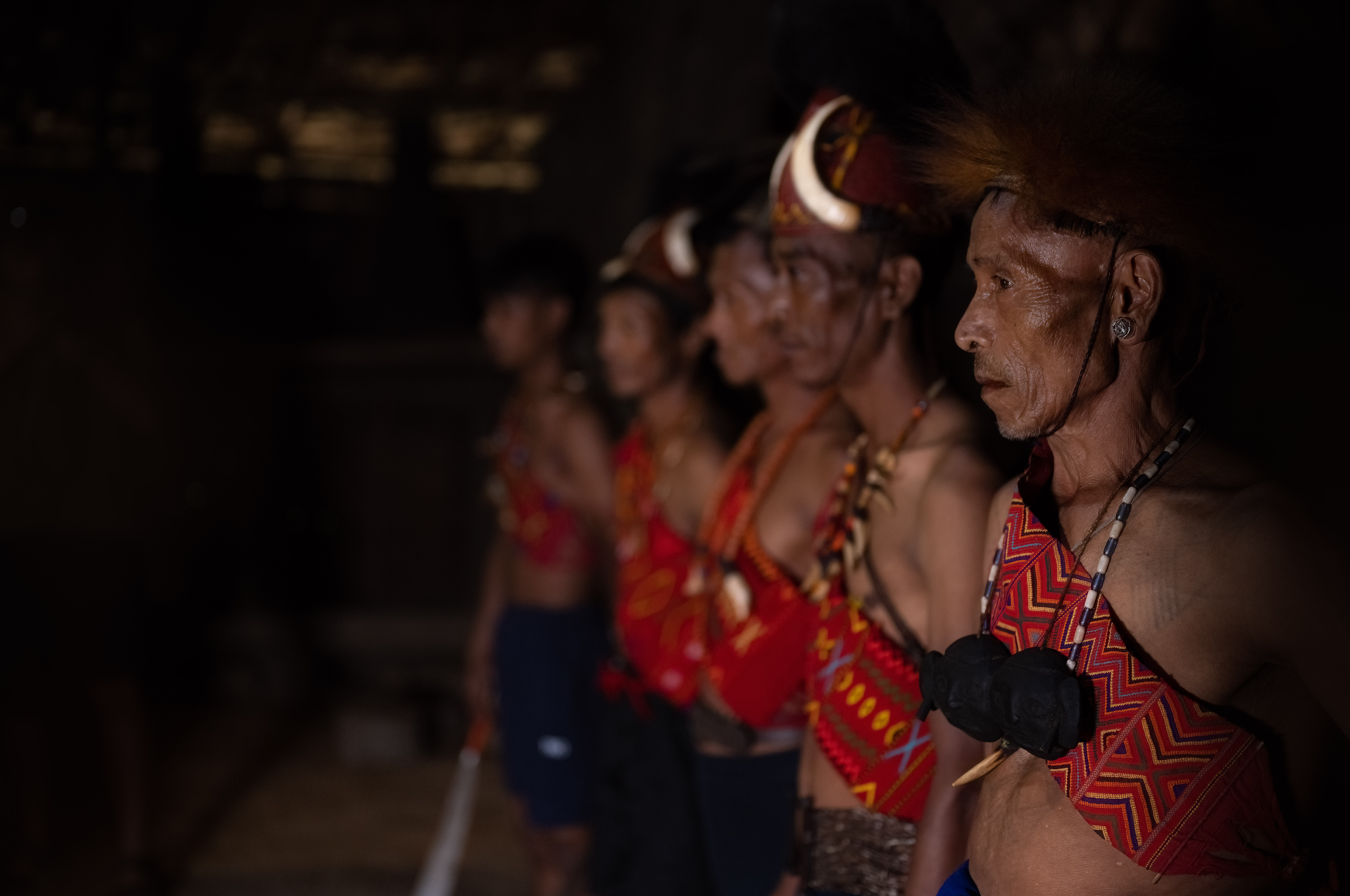 Young men in cultural dress perform ceremonial dances